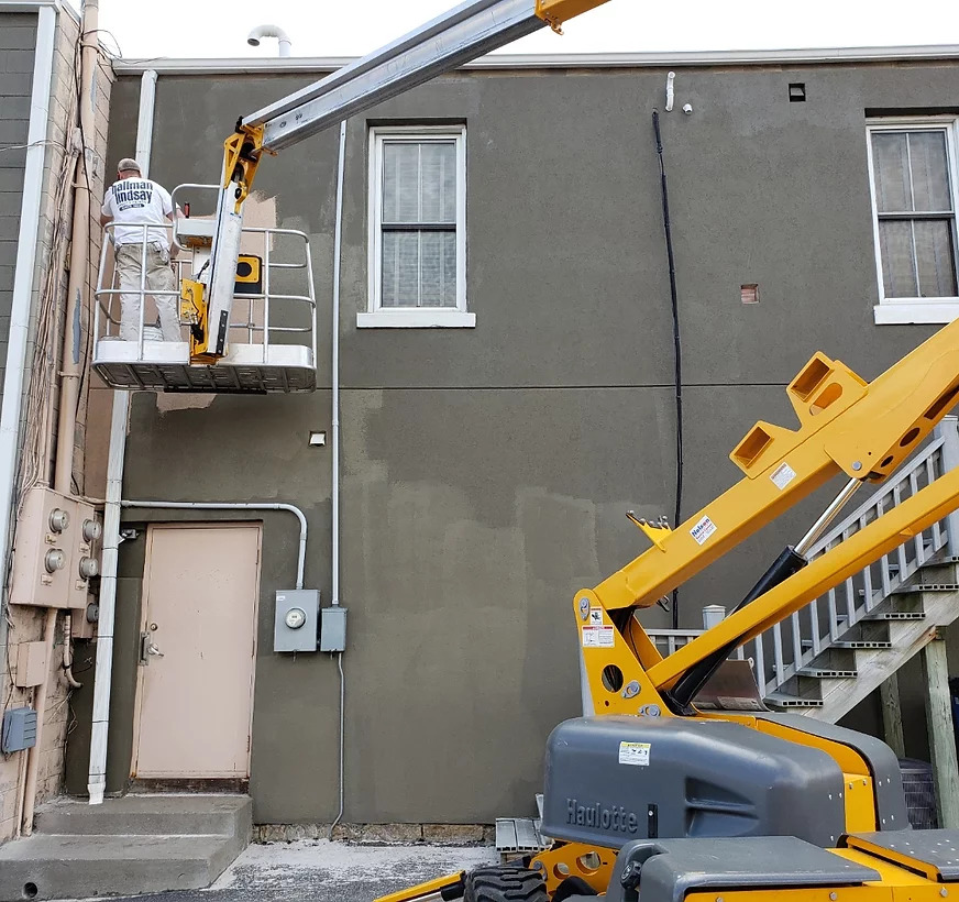 Joe Painting an exterior building
